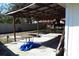 Covered patio with exposed rafter beams, table, and partially fenced perimeter at 5626 Sawyer Rd, Lakeland, FL 33810