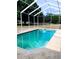 Sparkling in-ground pool featuring an enclosure and a spacious patio area at 5626 Sawyer Rd, Lakeland, FL 33810