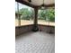 The screened-in porch has brick and tile, creating a versatile outdoor space for relaxation and entertainment at 5626 Sawyer Rd, Lakeland, FL 33810