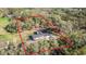 Aerial view of a house surrounded by lush trees, property lines marked in red for clarity at 5908 Lunn Rd, Lakeland, FL 33811