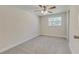 Inviting bedroom featuring neutral carpet, a ceiling fan, and a bright window at 5908 Lunn Rd, Lakeland, FL 33811