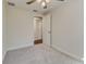 Cozy bedroom with neutral carpet, ceiling fan, and open doorway to other rooms at 5908 Lunn Rd, Lakeland, FL 33811