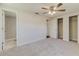 Bedroom with a ceiling fan and a door leading to the tiled shower at 5908 Lunn Rd, Lakeland, FL 33811