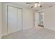 Well-lit bedroom with neutral carpet, double closet, and ensuite bathroom entrance at 5908 Lunn Rd, Lakeland, FL 33811