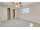 Bedroom featuring plush carpeting, a window, and a double-door closet at 5908 Lunn Rd, Lakeland, FL 33811