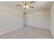 Bright bedroom with neutral carpet, ceiling fan, and closet at 5908 Lunn Rd, Lakeland, FL 33811