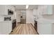 Beautiful kitchen featuring stainless steel appliances, white cabinets, subway tile, and wood floors at 5908 Lunn Rd, Lakeland, FL 33811