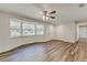 Bright living room featuring wood floors, a ceiling fan, and large bay window allowing natural light at 5908 Lunn Rd, Lakeland, FL 33811