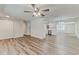 Open-concept living space with wood floors, ceiling fan, and open view to the kitchen at 5908 Lunn Rd, Lakeland, FL 33811