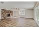 Spacious living room featuring a brick fireplace and sliding glass doors to the outdoors at 5908 Lunn Rd, Lakeland, FL 33811