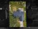 Overhead image of the home, highlighting the roof and backyard amidst lush trees at 5942 White Tail Loop, Lakeland, FL 33811