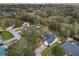 Aerial view of a home situated in a lush, green neighborhood with mature trees and well-maintained lawns at 5942 White Tail Loop, Lakeland, FL 33811