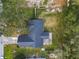 Aerial shot showcases home's roof, surrounding trees, and spacious lot at 5942 White Tail Loop, Lakeland, FL 33811