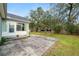 Home's backyard with a concrete patio, and green grass at 5942 White Tail Loop, Lakeland, FL 33811