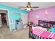 Colorful bedroom with a ceiling fan, a closet, toys and pink and blue walls at 5942 White Tail Loop, Lakeland, FL 33811