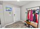 Inviting entryway featuring tile floors, a storage bench, and convenient coat rack at 5942 White Tail Loop, Lakeland, FL 33811