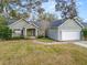 Charming single-story home features a well-manicured front yard and a two-car garage at 5942 White Tail Loop, Lakeland, FL 33811