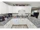 A functional kitchen with white cabinetry, granite counters and stainless sink at 5942 White Tail Loop, Lakeland, FL 33811