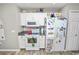 A galley kitchen featuring white cabinets, granite countertops, and a modern stove with microwave at 5942 White Tail Loop, Lakeland, FL 33811