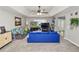 Inviting living room with a tray ceiling, ceiling fan, and large windows at 5942 White Tail Loop, Lakeland, FL 33811