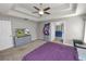 A comfortable bedroom with a carpet floor, ceiling fan, and en-suite bathroom at 5942 White Tail Loop, Lakeland, FL 33811