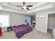 Spacious bedroom featuring tray ceilings, a ceiling fan, and carpet flooring at 5942 White Tail Loop, Lakeland, FL 33811