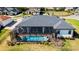 Aerial view of home with screened-in lanai, featuring a private pool and well-kept backyard at 6018 Abbey Oaks Dr, Lakeland, FL 33811