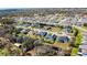 Neighborhood aerial view showing homes backing up to the water with lots of trees and lush landscaping at 6018 Abbey Oaks Dr, Lakeland, FL 33811