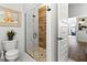 Modern bathroom featuring a walk-in shower with pebble floor and wood accent wall at 6018 Abbey Oaks Dr, Lakeland, FL 33811