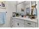 Bathroom vanity with white cabinets, quartz countertop, and decorative accents at 6018 Abbey Oaks Dr, Lakeland, FL 33811