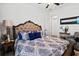 Bright bedroom featuring an upholstered headboard, ceiling fan, and en-suite access at 6018 Abbey Oaks Dr, Lakeland, FL 33811