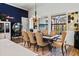 Open concept dining room with neon light, chandelier, and view to the screened in pool at 6018 Abbey Oaks Dr, Lakeland, FL 33811