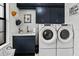 Well-organized laundry room with modern front-loading washer and dryer, plus stylish navy blue cabinets at 6018 Abbey Oaks Dr, Lakeland, FL 33811