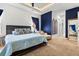 Main bedroom featuring a cozy sitting area, blue accent wall, and natural light from the window at 6018 Abbey Oaks Dr, Lakeland, FL 33811