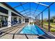 Relaxing screened-in pool area features a covered patio, in-pool seating, and ample space for lounging at 6018 Abbey Oaks Dr, Lakeland, FL 33811