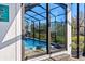 View of the screened-in pool area through sliding glass doors, blending indoor and outdoor living spaces at 6018 Abbey Oaks Dr, Lakeland, FL 33811