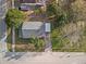 Overhead view of a single-Gathering home with mature trees, driveway, and sidewalk at 602 E Orange St, Auburndale, FL 33823