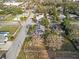 An aerial view of a neighborhood with a single-Gathering home and mature trees on a sunny day at 602 E Orange St, Auburndale, FL 33823