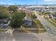 Aerial view of the charming home with a porch, fenced yard and mature trees at 602 E Orange St, Auburndale, FL 33823