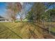 Large backyard with mature trees and a chain link fence at 602 E Orange St, Auburndale, FL 33823