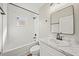 Updated bathroom featuring subway tiles, white cabinets, and a black framed mirror at 602 E Orange St, Auburndale, FL 33823