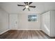 Bedroom featuring a ceiling fan, hardwood floors and a storage unit at 602 E Orange St, Auburndale, FL 33823