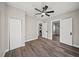 Bright bedroom with hardwood floors, ceiling fan, and modern white doors at 602 E Orange St, Auburndale, FL 33823