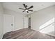 Spacious bedroom with ceiling fan and white doors at 602 E Orange St, Auburndale, FL 33823