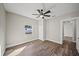 Bedroom featuring laminate wood flooring, fresh paint, ceiling fan and single window at 602 E Orange St, Auburndale, FL 33823