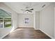 Bedroom with neutral walls, laminate wood flooring, modern ceiling fan and two windows at 602 E Orange St, Auburndale, FL 33823