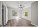 Bedroom with natural light featuring light neutral walls, laminate flooring, and a ceiling fan at 602 E Orange St, Auburndale, FL 33823