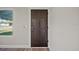 Close up shot of a painted front door with sidelight windows and laminate wood flooring at 602 E Orange St, Auburndale, FL 33823