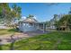 A view of the home showing the covered carport and side yard at 602 E Orange St, Auburndale, FL 33823