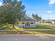 Charming home with a front porch, fenced yard and mature trees at 602 E Orange St, Auburndale, FL 33823